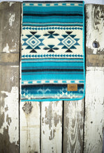 Load image into Gallery viewer, Pictured is an aqua blue, light grey, slate blue, light blue, dark teal blue, black, dark cyan blue and white coloured, traditional Aztec patterned baby blanket. This is the Heartprint Threads 'PNW Baby' Baby Blanket, created by Ecuadorian Artisans. Perfect for your everyday soft & warm baby blanket needs! Available for sale at SMRT Tent in Edmonton, Canada.