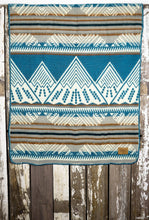 Load image into Gallery viewer, Pictured is a light grey, Crayola cerulean blue, greyish tan, cream, bronze brown and white coloured, mountain patterned baby blanket. This is the Heartprint Threads 'Sky Mini Sky' Baby Blanket, created by Ecuadorian Artisans. Perfect for your everyday soft & warm baby blanket needs! Available for sale at SMRT Tent in Edmonton, Canada.