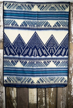 Load image into Gallery viewer, Pictured is a light slate blue, darkish aqua blue, light grey, pale sky blue, dark blue and white coloured, mountain patterned baby blanket. This is the unfolded Heartprint Threads 'Small and Mighty' Baby Blanket, created by Ecuadorian Artisans. Perfect for your everyday soft & warm baby blanket needs! Available for sale at SMRT Tent in Edmonton, Canada.