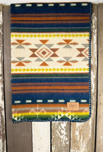 Load image into Gallery viewer, Pictured is a dark blue, light tannish grey, coppery brown, orange, yellow, grass green, forest green, cream, pale brown and white coloured, traditional Aztec patterned baby blanket. This is the Heartprint Threads 'Vintage Baby' Baby Blanket, created by Ecuadorian Artisans. Perfect for your everyday soft & warm baby blanket needs! Available for sale at SMRT Tent in Edmonton, Canada.