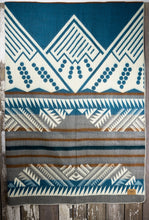 Load image into Gallery viewer, Pictured is a grey, brown, cream & Crayola cerulean blue, mountain-patterned and laid-out blanket. This is the Heartprint Threads 'Sky Blue Sky' Mountain Flakes Line Queen Blanket, created by Ecuadorian Artisans. Throw this warm blanket over your sleeping bag while camping outdoors! Available for sale at SMRT Tent in Edmonton, Canada.