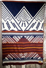 Load image into Gallery viewer, Pictured is a ultramarine blue-violet, red, orange & cream, mountain-patterned and laid-out blanket. This is the Heartprint Threads 'Wolf Moon' Mountain Flakes Line Queen Blanket, created by Ecuadorian Artisans. Throw this warm blanket over your sleeping bag while camping outdoors! Available for sale at SMRT Tent in Edmonton, Canada.