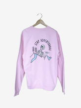 Load image into Gallery viewer,  Pictured is the back of our Pink Skeleton Crewneck that depicts an enlarged version of our White laughing skeleton above and overlapping a mountain range with two simple pine trees in Black to its right (our left) and the words Stay Adventurous written in Black above the image. 2 parts of the mountain range are shaded by a baby blue. This Crewneck is perfect to bring along on your overland roof top tent camping adventure! Available for sale by SMRT Tent in Edmonton, Canada.