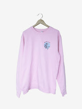 Load image into Gallery viewer, Pictured is the front of a Pink Crewneck Sweatshirt that has a print over the upper left chest area. The print is a White, laughing skeleton over a Teal, circle frame with the words SMRT Tent EST 2017 written above in Black. Perfect to bring along on your overland roof top tent camping adventure! Available for sale by SMRT Tent in Edmonton, Canada.