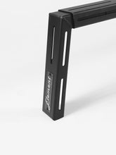 Load image into Gallery viewer, Pictured is a close-up of one corner of the assembled, 6-inch aluminum crossbar. This is the Universal Bed Crossbar Kit, perfect for any truck bed in your overland roof top tent camping! Available for sale by SMRT Tent in Edmonton, Canada.