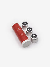 Load image into Gallery viewer, Pictured is a red cylinder with white top and bottom end caps and the letters VSSL written in white below it on the body of the cylinder. To its right side are three metal tins holding all the supplies. This is the unpacked compact VSSL First Aid Mini. Perfect for your roof top tent camping or hiking first aid needs! Available for sale by SMRT Tent in Edmonton, Canada.
