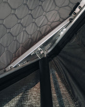 Load image into Gallery viewer, Pictured in a close-up is the inside of a completely set-up hard shell roof top tent in grey. The close view shows the quilted inside that lets this tent be used for all 4 seasons and eliminates the need for an anti-condensation mat. This is the medium-sized Sky Loft, a 2-person hard shell roof top tent perfect for all overland roof top tent family outdoor camping! Available for sale by SMRT Tent in Edmonton, Canada.