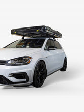 Load image into Gallery viewer, Pictured is a completely packed-up hard shell roof top tent secured on top of a VW Jetta Hatchback roof. This is the medium-sized Sky Loft, a 2-person hard shell roof top tent perfect for all overland roof top tent family outdoor camping! Available for sale by SMRT Tent in Edmonton, Canada.