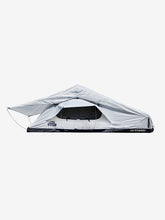Load image into Gallery viewer, Pictured in a light, white-ish grey is a completely set-up softshell roof top tent. This is “The” Softshell, a roof top tent perfect for all overland roof top tent family outdoor camping! Available for sale by SMRT Tent in Edmonton, Canada.