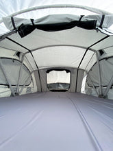 Load image into Gallery viewer, Pictured in a light, white-ish grey is the spacious inside of a completely set-up softshell roof top tent. This is “The” Softshell, a roof top tent perfect for all overland roof top tent family outdoor camping! Available for sale by SMRT Tent in Edmonton, Canada.