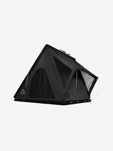 Load image into Gallery viewer, Pictured is a matte, all-black, completely set-up hard shell roof top tent. This is the Summit Suite, a large (2-person) hard shell roof top tent in Stealth Black. Perfect for any overland hard shell roof top tent camp adventure! Available for sale by SMRT Tent in Edmonton, Canada.
