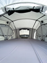 Load image into Gallery viewer, Pictured in a light, white-ish grey is the spacious inside of a completely set-up softshell roof top tent. This is “The” Softshell, a roof top tent perfect for all overland roof top tent family outdoor camping! Available for sale by SMRT Tent in Edmonton, Canada.
