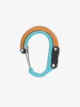 Load image into Gallery viewer, Pictured in metallic orange for the swivel hook and bright blue for the rest of the clip is a closed, medium-sized metal carabiner. This is the HeroClip Medium in Solar Flare. Perfect for your roof top tent adventure camp tool hanging needs! Available for sale by SMRT Tent in Edmonton, Canada.
