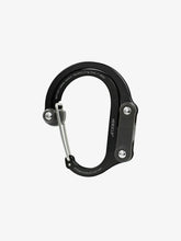 Load image into Gallery viewer, Pictured in black for the swivel hook and the inner clip is a closed, medium-sized metal carabiner. This is the HeroClip Medium in Stealth Black. Perfect for your roof top tent adventure camp tool hanging needs! Available for sale by SMRT Tent in Edmonton, Canada.
