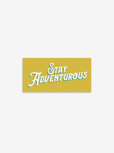 Pictured is a yellow rectangular sticker with the words Stay Adventurous in white and shadowed in teal. Perfect to show your passion for outdoor roof top tent camping! Available for sale by SMRT Tent in Edmonton, Canada.