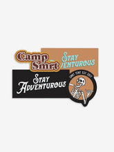 Load image into Gallery viewer, Pictured are the 4 stickers in the Retro Warm tones of our SMRT Tent Sticker Pack. Included are (1) Camp SMRT Retro Brown, orange and white sticker, (2) Rectangular Stay Adventurous stickers (1 coloured in black and white, 1 coloured in peach and teal), and (1) Classic Orange &amp; Black Laughing Skeleton SMRT Tent EST 2017 sticker. Perfect for your roof top tent or water bottle! Available for sale by SMRT Tent in Edmonton, Canada.
