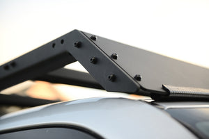 Pictured is a close-up of the right-front corner of the assembled 10-20 4Runner 5th Gen Modular Roof Rack, showing the assembly points and the diffuser on top the silver Toyota SUV roof. The perfect fit and most compatible choice of modular roof rack for your Toyota 4Runner 5th Gen SUV! Available for sale by SMRT Tent in Edmonton, Canada.