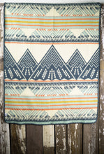 Load image into Gallery viewer, Pictured is a light blue, orange, golden yellow, light grey, dark slate blue and cream coloured, mountain patterned baby blanket. This is the Heartprint Threads &#39;Mountain Lion&#39; Baby Blanket, created by Ecuadorian Artisans. Perfect for your everyday soft &amp; warm baby blanket needs! Available for sale at SMRT Tent in Edmonton, Canada.
