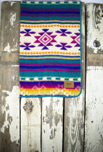Load image into Gallery viewer, Pictured is a violet, lightly sandy white, bright yellow, pale yellow, bright orange, magenta, cream, purple and white coloured, traditional Aztec patterned baby blanket. This is the technicolour Heartprint Threads &#39;Wild One&#39; Baby Blanket, created by Ecuadorian Artisans. Perfect for your everyday soft &amp; warm baby blanket needs! Available for sale at SMRT Tent in Edmonton, Canada.
