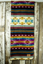 Load image into Gallery viewer, Pictured is a technicolour, patterned and laid-out blanket. This is the Heartprint Threads ‘Colourful Minds’ Aztec Series Double Blanket, created by Ecuadorian Artisans. Throw this warm blanket over your sleeping bag while camping outdoors! Available for sale at SMRT Tent in Edmonton, Canada.

