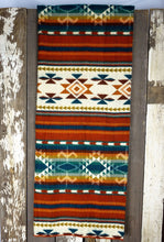 Load image into Gallery viewer, Pictured is a red &amp; blue, patterned and laid-out blanket. This is the Heartprint Threads &#39;Fire at Night&#39; Aztec Series Double Blanket, created by Ecuadorian Artisans. Throw this warm blanket over your sleeping bag while camping outdoors! Available for sale at SMRT Tent in Edmonton, Canada.
