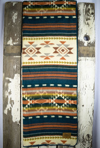 Pictured is an orange, patterned and laid-out blanket. This is the Heartprint Threads ‘Vintage Velvet’ Aztec Series Double Blanket, created by Ecuadorian Artisans. Throw this warm blanket over your sleeping bag while camping outdoors! Available for sale at SMRT Tent in Edmonton, Canada.