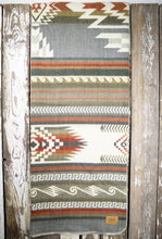 Load image into Gallery viewer, Pictured is a grey &amp; olive, wave-patterned and laid-out blanket. This is the Heartprint Threads &#39;Mosaic Pebble&#39; Maskuy Collection Queen Blanket, created by Ecuadorian Artisans. Throw this warm blanket over your sleeping bag while camping outdoors! Available for sale at SMRT Tent in Edmonton, Canada.
