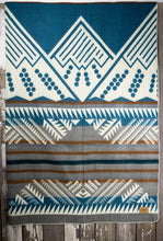 Load image into Gallery viewer, Pictured is a grey, brown, cream &amp; Crayola cerulean blue, mountain-patterned and laid-out blanket. This is the Heartprint Threads &#39;Sky Blue Sky&#39; Mountain Flakes Line Queen Blanket, created by Ecuadorian Artisans. Throw this warm blanket over your sleeping bag while camping outdoors! Available for sale at SMRT Tent in Edmonton, Canada.
