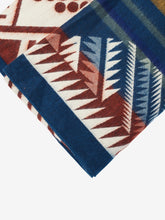 Load image into Gallery viewer, Pictured is a close-up of a dark blue, mountain-patterned and neatly folded blanket. This is a Heartprint Threads ‘The Bench’ Mountain Flakes Line Queen Blanket, created by Ecuadorian Artisans.  Throw this warm blanket over your sleeping bag while camping outdoors! Available for sale at SMRT Tent in Edmonton, Canada.
