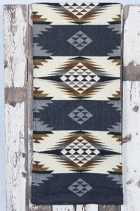 Pictured is a slate-coloured, patterned and laid-out blanket. This is the Heartprint Threads 'Anchor' Queen Blanket, created by Ecuadorian Artisans. Throw this warm blanket over your sleeping bag while camping outdoors! Available for sale at SMRT Tent in Edmonton, Canada.