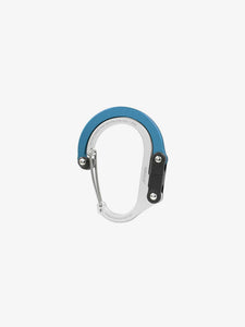 Pictured in metallic blue for the closed swivel hook and silver for the rest of the clip, is a small-sized metal carabiner. This is the HeroClip Small in Blue Steel. Perfect for your roof top tent adventure camp tool hanging needs! Available for sale by SMRT Tent in Edmonton, Canada.