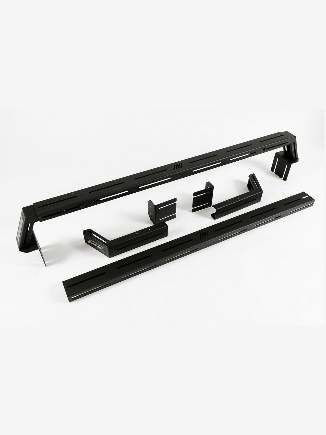 Pictured are two black, 6-inch aluminum crossbars. One is fully assembled and the other is neatly disassembled. This is the Universal Bed Crossbar Kit, perfect for any truck bed in your overland roof top tent camping! Available for sale by SMRT Tent in Edmonton, Canada.