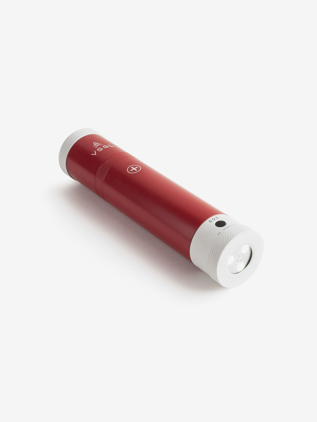 Pictured is a red cylinder, the top end has a white end cap and the letters VSSL written in white below it on the body of the cylinder, with the other white end cap being a flashlight. This is the packed compact VSSL First Aid. Perfect for your overland canada roof top tent camping first aid kit needs! Available for sale by SMRT Tent in Edmonton, Canada.