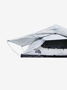 Pictured in a white-ish light grey is an attachable rainfly for roof top tents. This is “The” Softshell Rainfly, a roof top tent rainfly perfect for all overland roof top tent family outdoor camping! Available for sale by SMRT Tent in Edmonton, Canada.